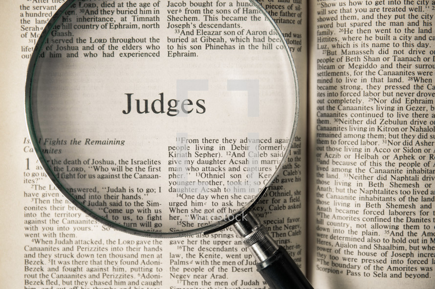 magnifying glass over Bible - Judges 