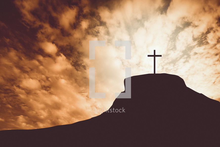 silhouette of a cross on a mount at sunset 