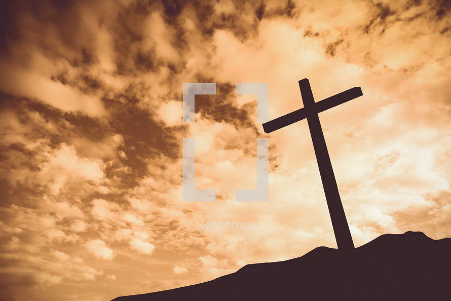 silhouette of a cross on a mount at sunset 