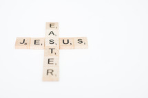 cross made from scrabble pieces forming the words Jesus and Easter