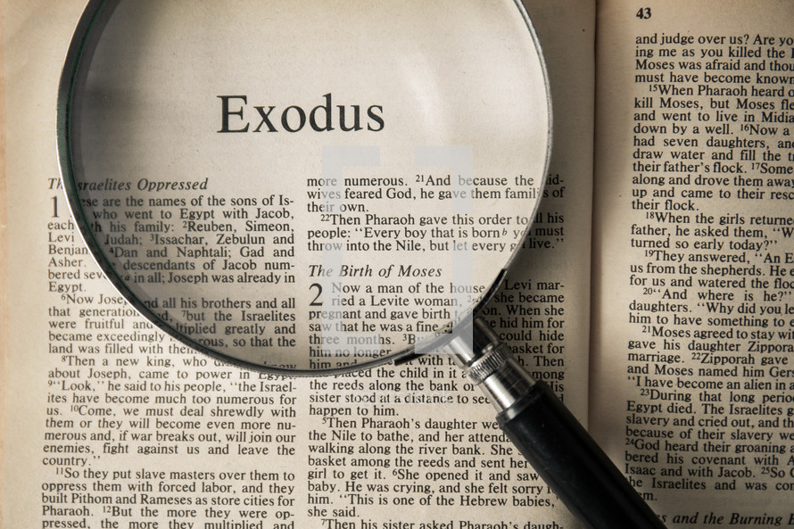 magnifying glass over Bible - Exodus 