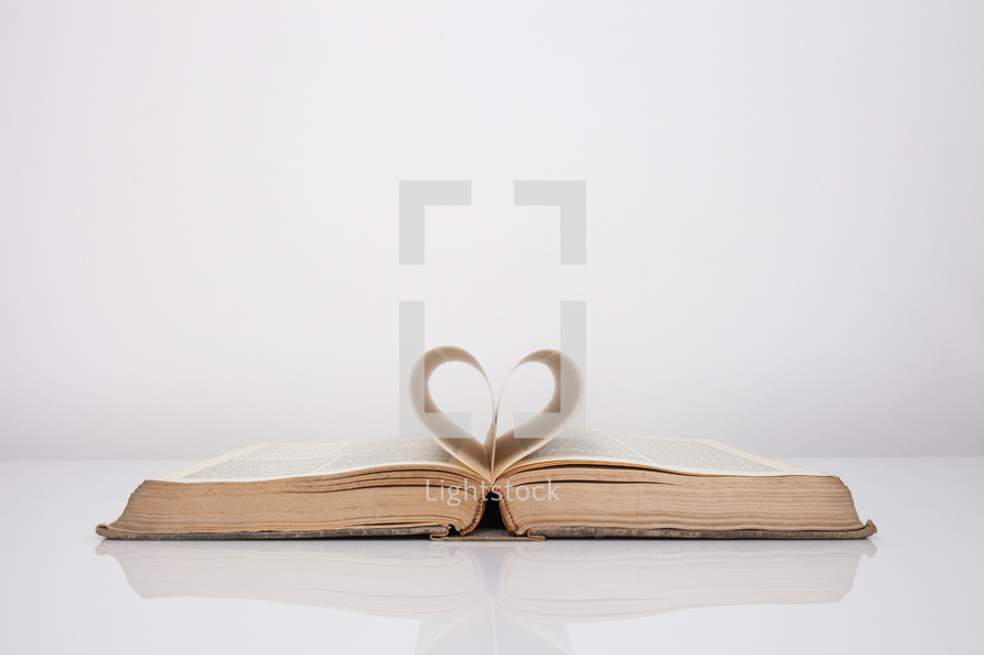 pages of a Bible folding into the shape of a heart 