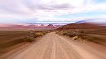 Dirt road in southwest with motion blur and clouds
