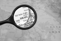 Magnifying glass on a map of the Middle East.