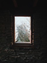 view of a rock peak out a window 