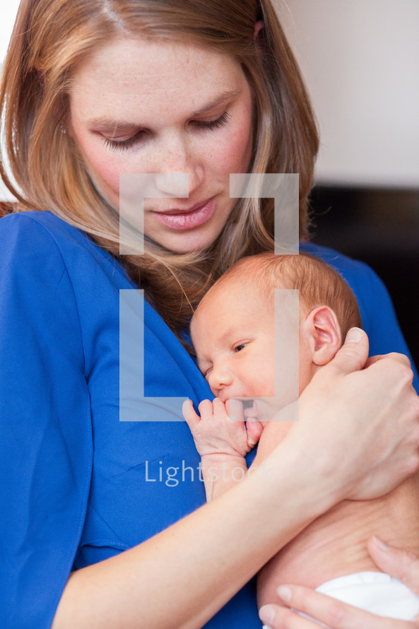 a mother holding a newborn baby 