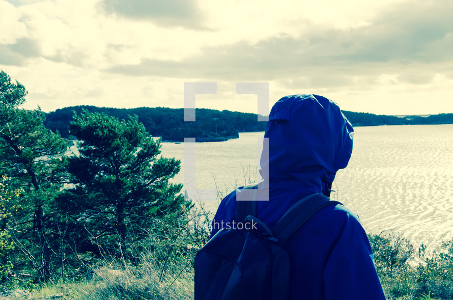 a man exploring a lake shore 