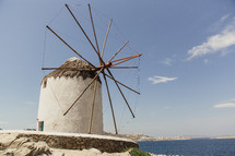 A windmill by the sea.