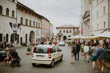 people walking around a town square