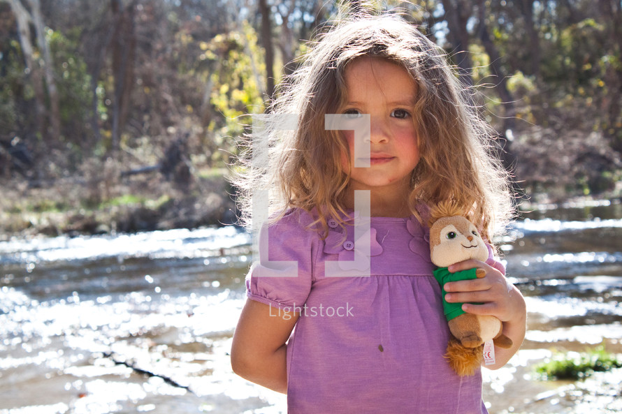 girl child holding onto a stuffed animal 