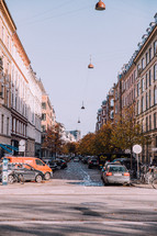 cars parked along a cobblestone street in Copenhagen 