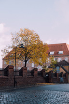 a brick wall and cobblestone street in Copenhagen 