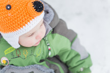 A baby in winter clothing.