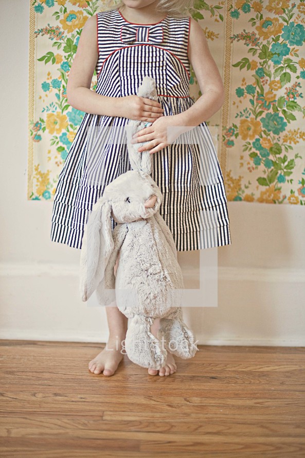 child holding a stuffed animal bunny