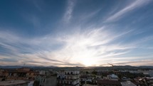 White clouds veil the blue sky