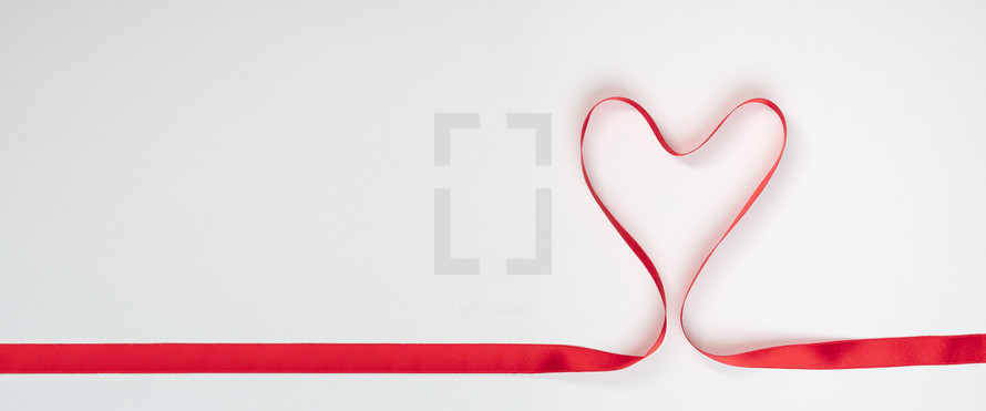 red ribbon in the shape of a heart 