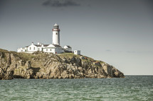 a lighthouse along a cliff 