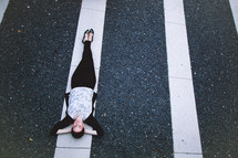 A woman lying in white lines. 