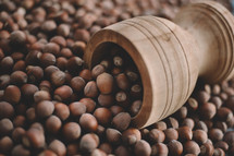 Hazelnuts in a wooden bowl on rustic background