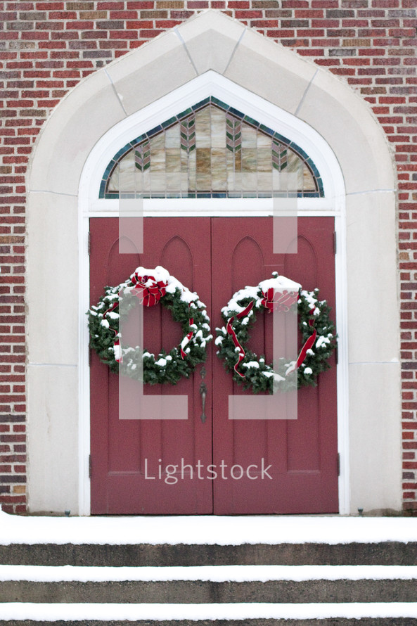 Christmas wreaths on a church's doors