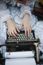 woman typing on a typewriter 