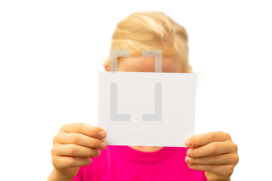 a girl holding up a blank piece of paper 