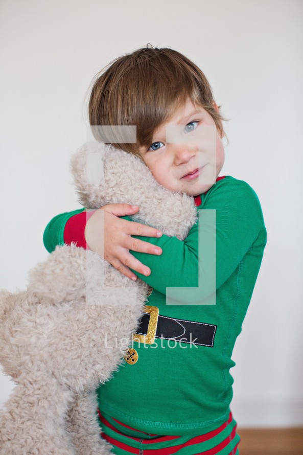 toddler hugging a stuffed animal 