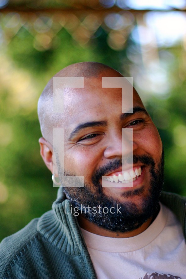 Man with goatee laughing