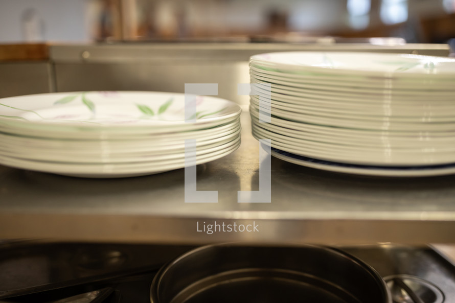 stack of dishes at a cafeteria