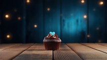 Chocolate cupcake on wooden table against bokeh lights background