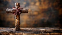 Wooden cross on a wooden background. The concept of the Christian faith.