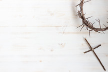 crown of thorns and cross on a white wood background 