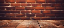 Wooden table against red brick wall with copy space for your text