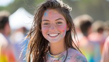 Young woman covered in colorful powder at a Holi festival