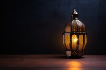 Arabic lantern on wooden table and dark background. Ramadan Kareem concept.