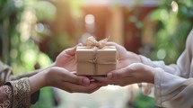 Woman Giving Gift to Friend or Family Member Wrapped in Brown Paper with String Bow