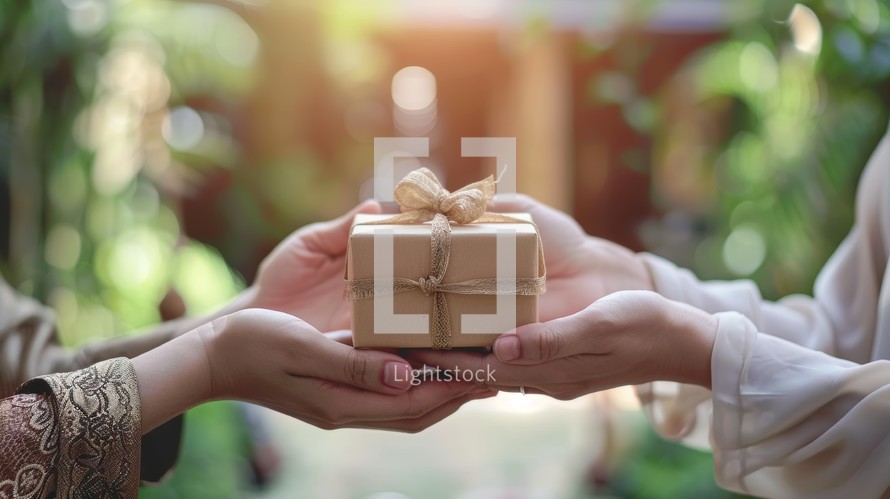 Woman Giving Gift to Friend or Family Member Wrapped in Brown Paper with String Bow