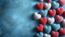 Red and white heart-shaped candies on a blue background.