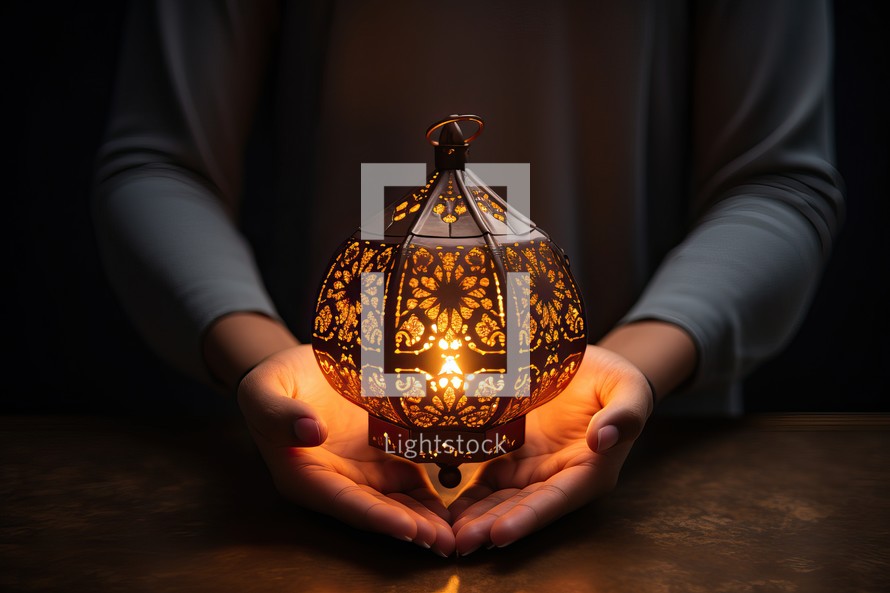 Female hands holding decorative lantern on dark background. Ramadan Kareem concept