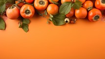 Ripe Persimmons on Vibrant Orange Background