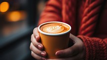 Close up of a woman hands holding a cup of coffee