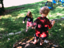 brother and sister playing in trier backyard