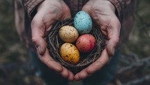 Hands holding colorful Easter eggs in nest. Spring holiday celebration concept.