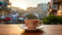 Coffee cup on the wooden table with cityscape background.