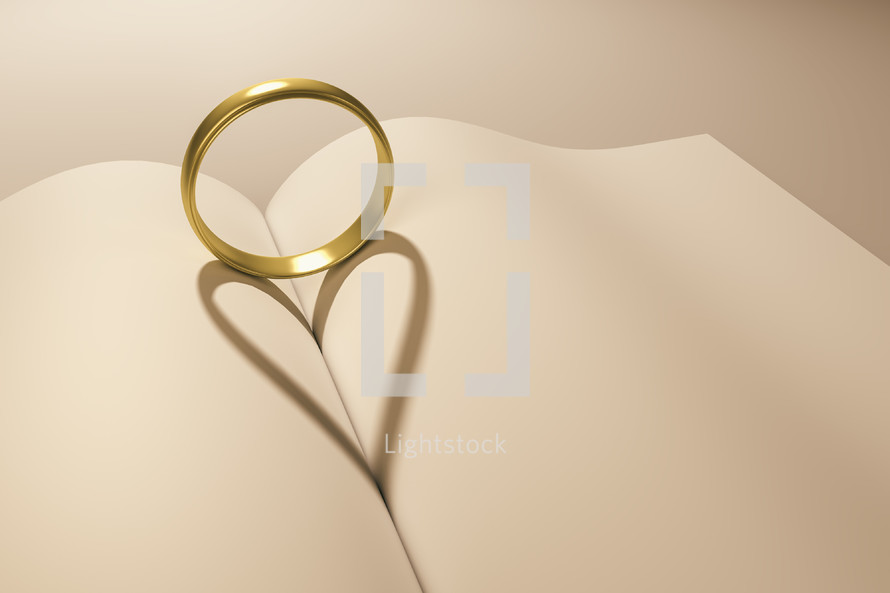 wedding band forming a heart shadow between the pages of a book 