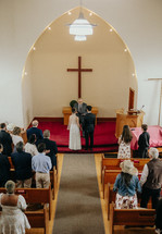 Wedding ceremony inside small church.
