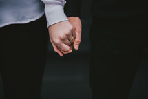 an engaged couple holding hands 