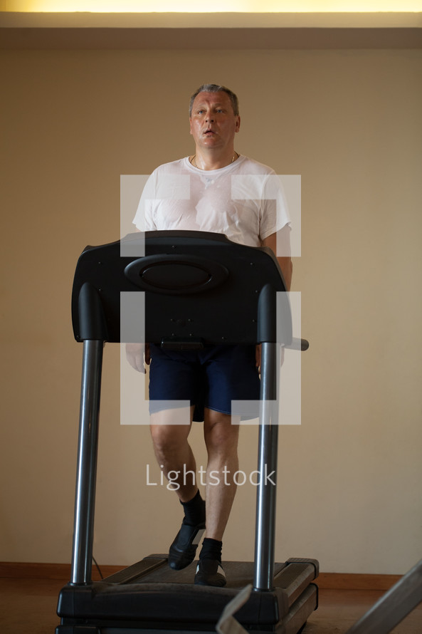 Middle-aged man working out on a treadmill
