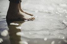 bare feet in wet sand 