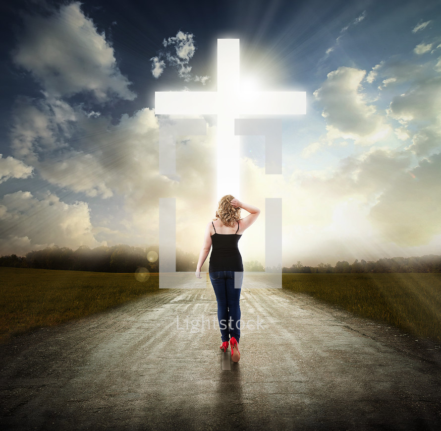 Woman walking in the middle of the road toward the light of Christ.